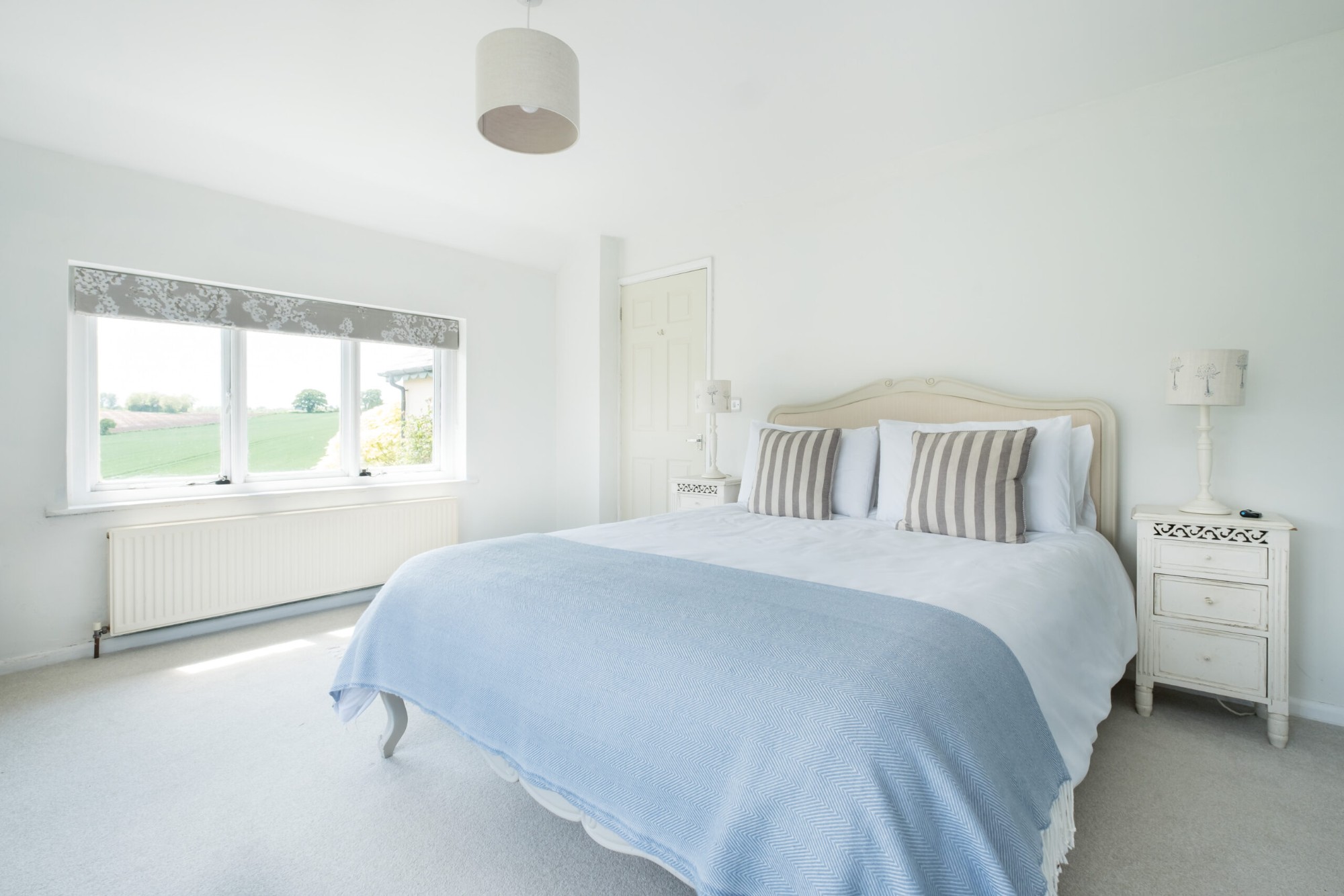 Master bedroom with king-size bed and countryside views